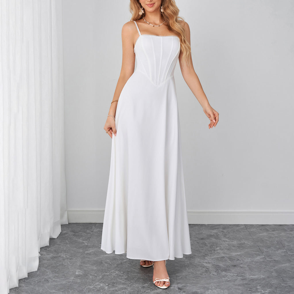 White sleeveless maxi dress with spaghetti straps and fitted bodice.