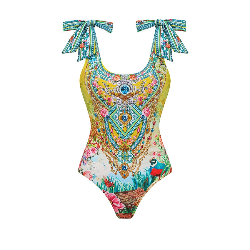 One-piece swimsuit in bright yellow with teal, floral paisley print and bow tie straps