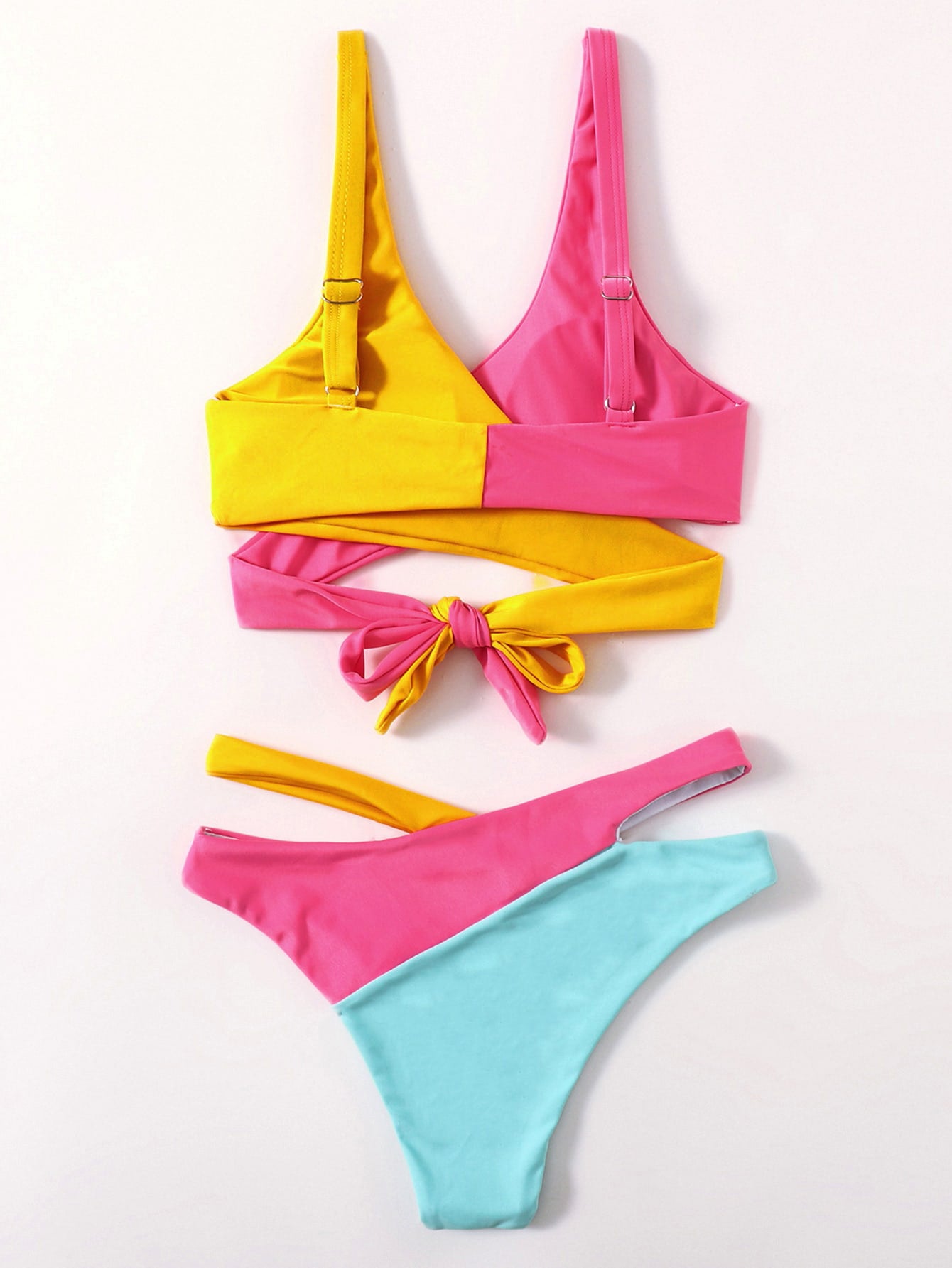 Multi-color one-piece swimsuit laid flat in yellow, hot pink, and aqua