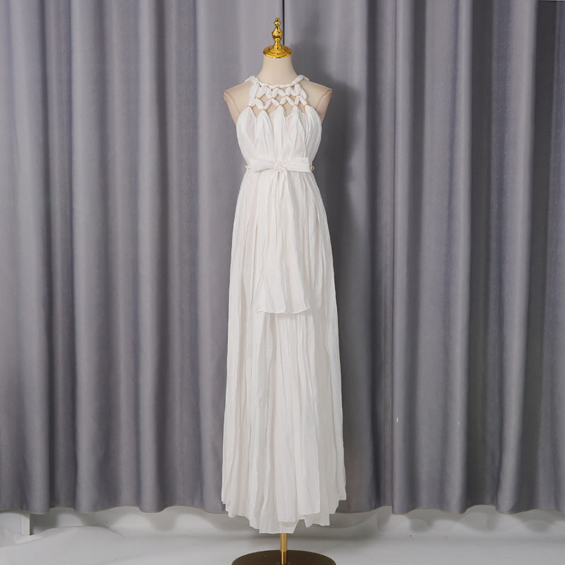White sleeveless spring dress on mannequin, lace halter bodice and belted waist, tiered skirt