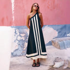 Women's positioning print dress in black with vertical white stripes and hem border