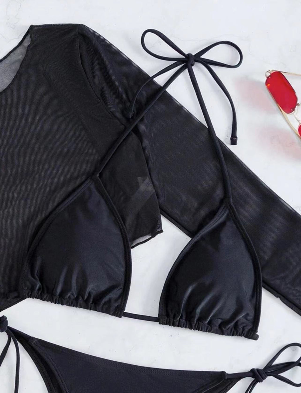 Black bikini swimwear set with sheer long-sleeve top and lace-up triangle ties