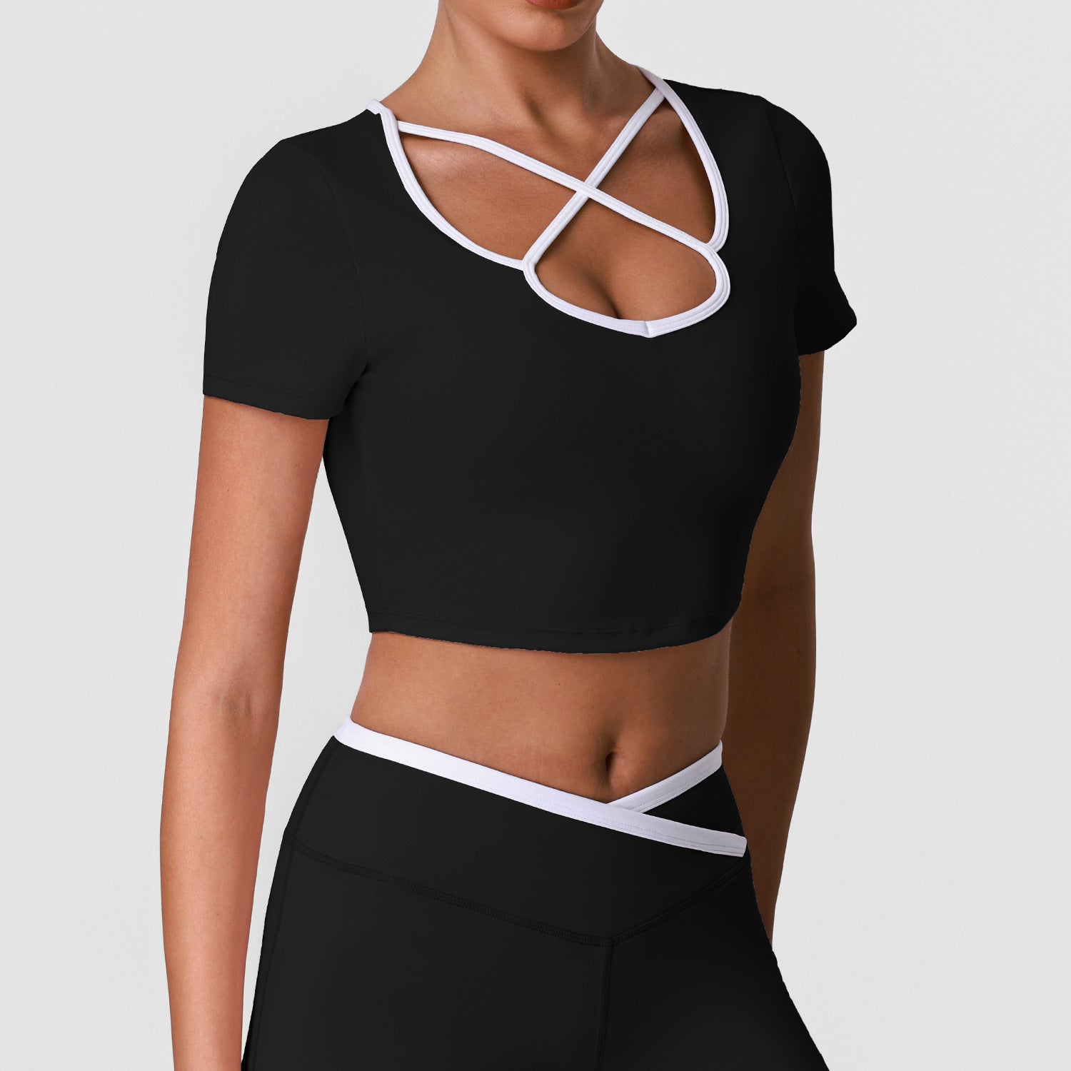 Women's sports crop top, black with white crisscross keyhole chest cutout, short sleeves