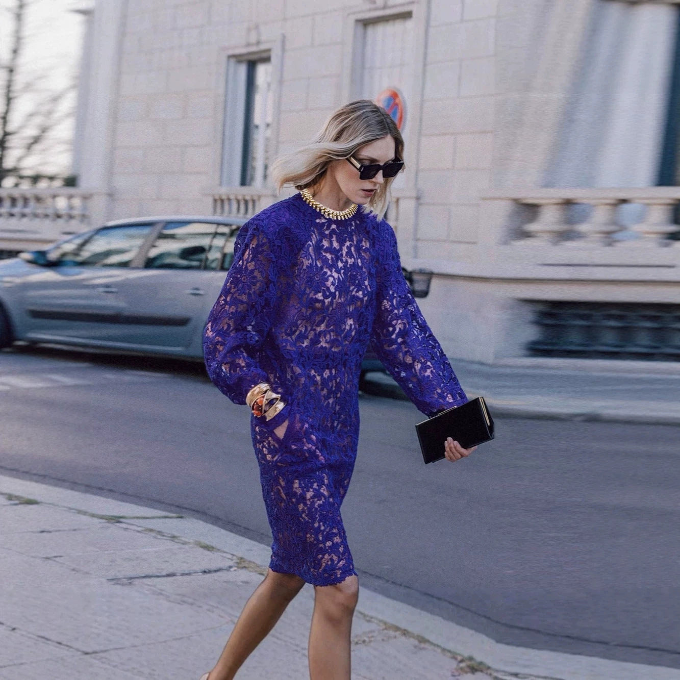 Navy lace long sleeve midi dress with ornate floral pattern, long sleeves and sheath fit.
