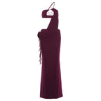 Burgundy halter maxi dress on mannequin with draped back and hanging side tassels