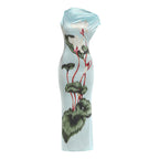 Light blue sheath summer dress with one-shoulder drape and green floral print, studio