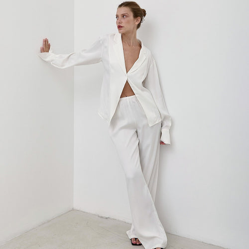 White satin pajama set with wrap-style top and long wide-leg trousers