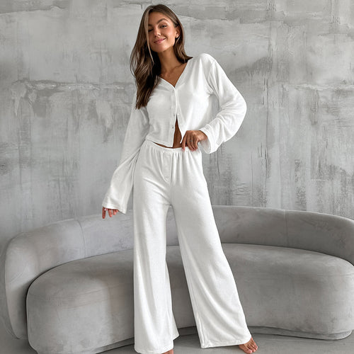 White button-front pajama set with long sleeves and wide-leg pants
