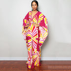 Pink, yellow, and red geometric one-piece swim dress with V-neck and flowing fit