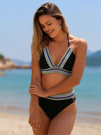 Black bikini top and matching bottoms with V-neck striped trim, side view