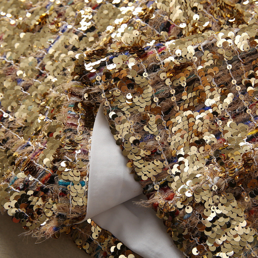 Gold sequin fabric with dense sparkle and colorful reflections on sheer underlayer