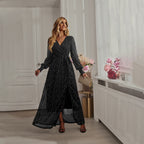 Black sequin maxi dress with V-neck, long puff sleeves, and front slit