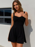 Black A-line sleeveless dress, square neckline, draped front, flared skirt