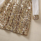 Gold sequin dress hem and sheer lace sleeve cuff with textured, sparkling trim