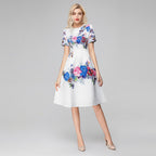 White floral sequin dress with short sleeves, fitted waist, full skirt, blue and pink blooms