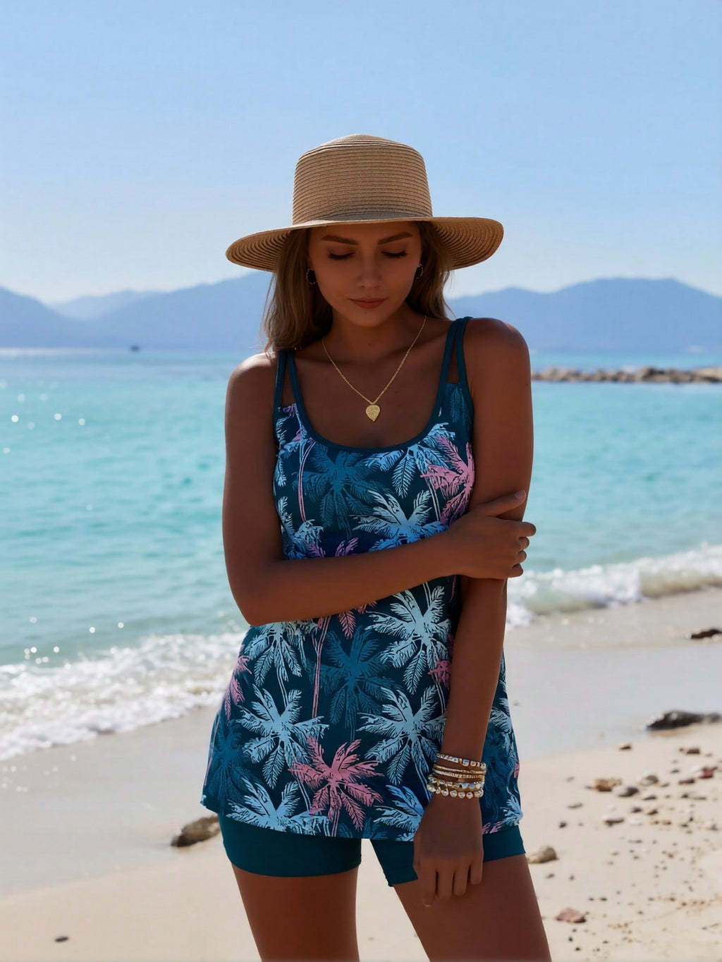 Blue floral one-piece swimsuit with spaghetti straps and matching teal swim shorts