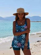 Blue floral one-piece swimsuit with spaghetti straps and matching teal swim shorts