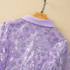 Lavender sequin fabric close-up from the back with point collar on hanger