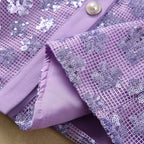 Close-up of lavender dress front corner with pearl-tone button and sequin mesh