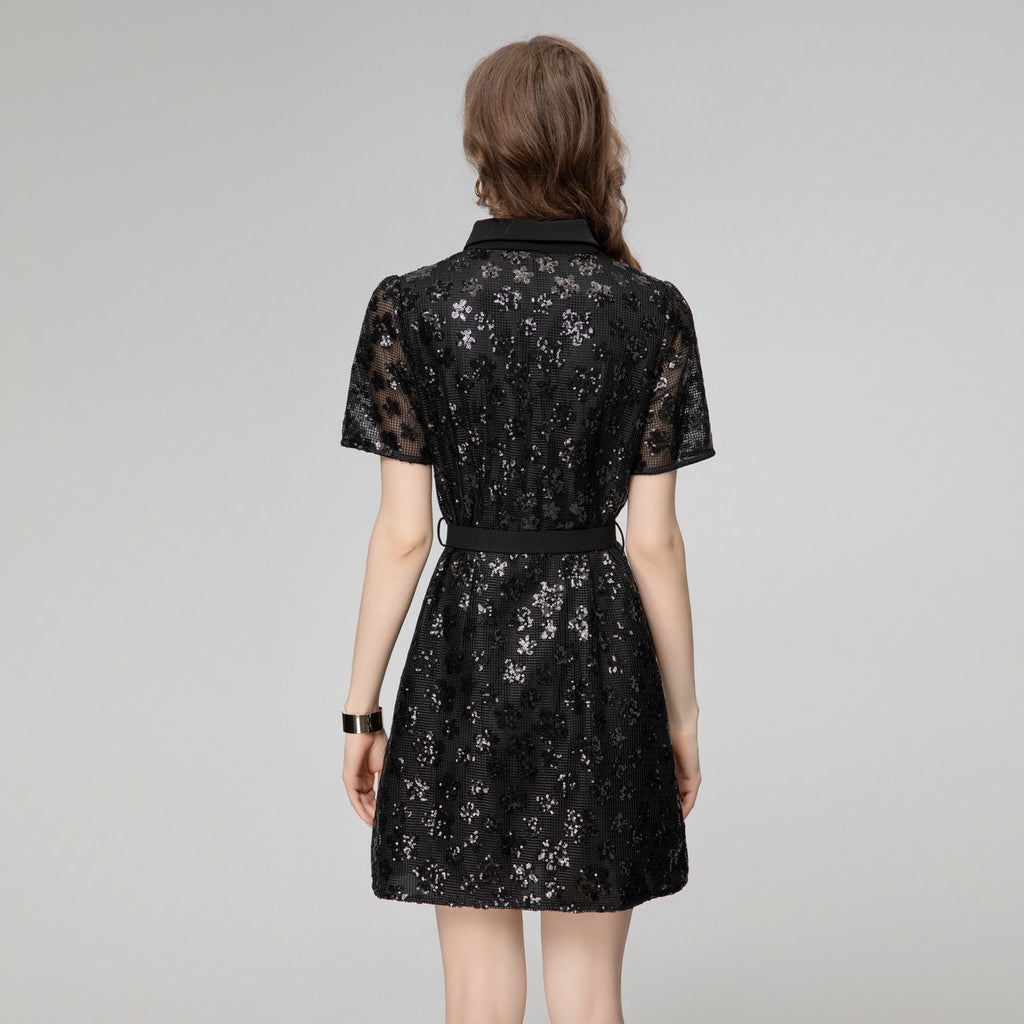 Black sequin short sleeve dress from back view with waist belt and button detail