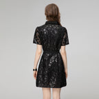 Black sequin short sleeve dress from back view with waist belt and button detail