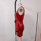 Red sequin sheath dress on mannequin with rose applique and sleeveless cut