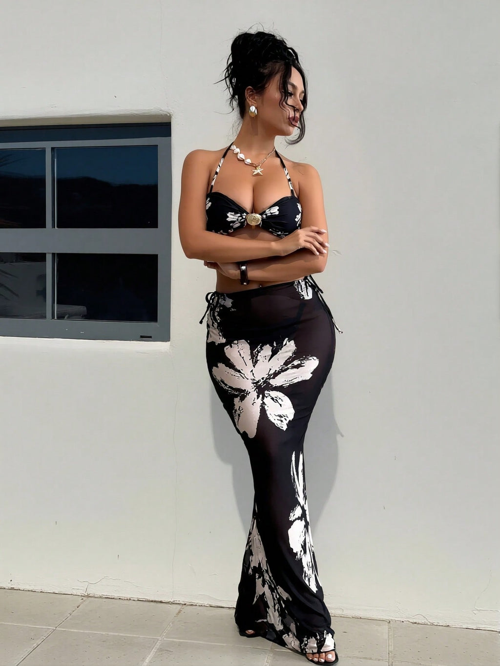 Black halter bikini with white floral print and matching long skirt