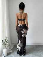 Back of black halter bikini with white floral print and matching long skirt