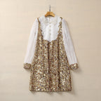 Gold sequin long-sleeve mini dress on hanger with sheer lace sleeves and button front