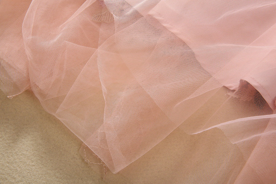 Pink layered tulle hem with delicate mesh texture and subtle sparkle