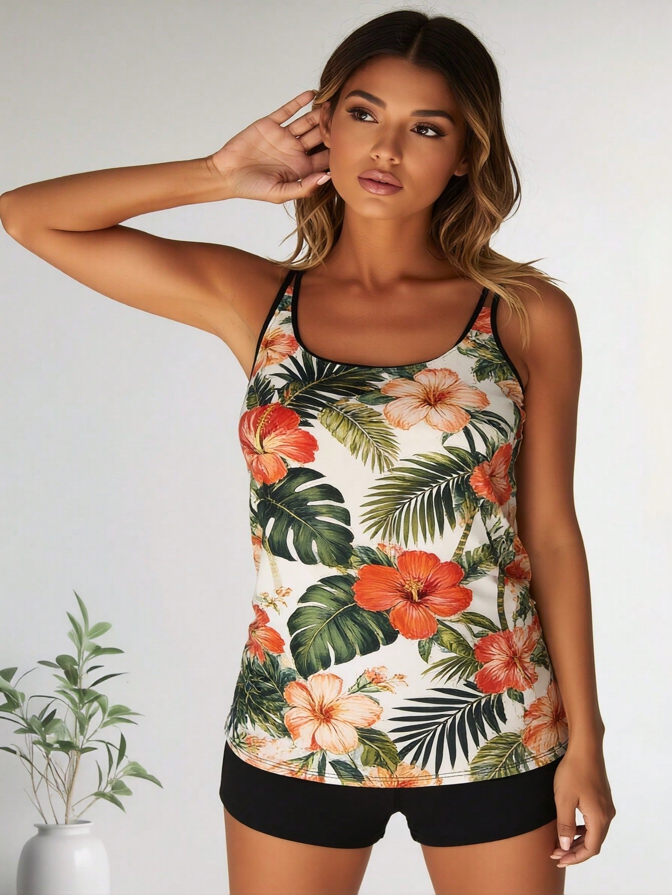 Tropical floral tankini with spaghetti straps and hibiscus print, black swim shorts