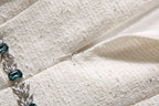 Beige textured sequin fabric with visible side zipper opening