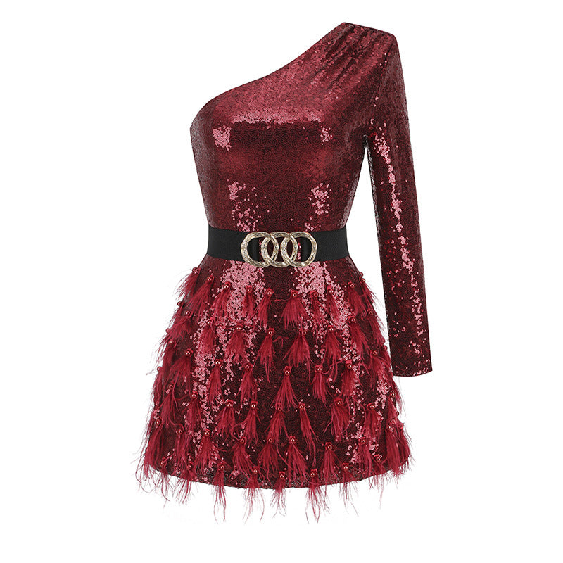 Red sequin mini dress back view with long sleeves, gold buckle belt, feather tulle skirt