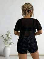 Black swim cover-up with sheer back and matching shorts, palm print