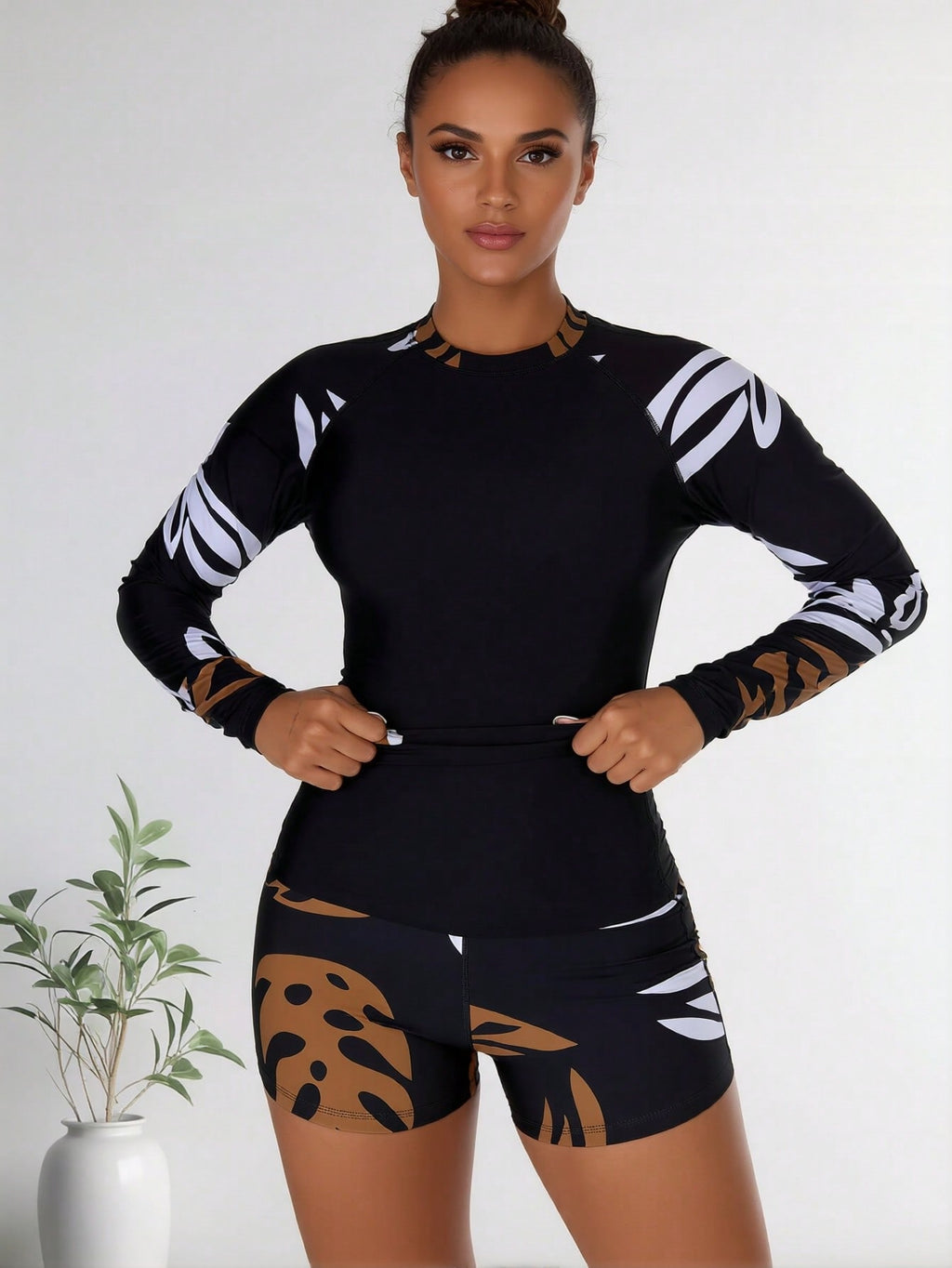 Black long-sleeve swim rash guard with white abstract leaf sleeves and boy shorts