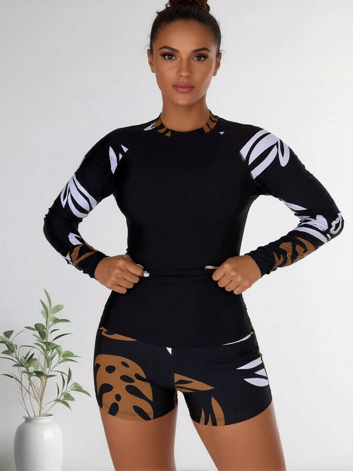 Black long-sleeve swim rash guard with white abstract leaf sleeves and boy shorts